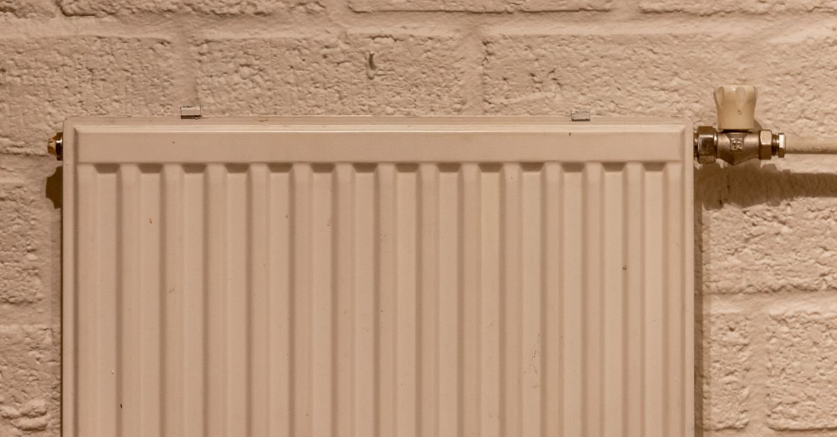 A white panel radiator mounted on a wall with a bleed valve visible in the top corner.